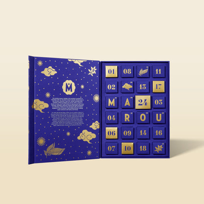 Blue advent calendar opened, showing numbered chocolate squares and MAROU letters