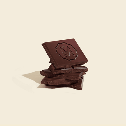Chocolate squares with rough surface stack, dark brown pieces for a bar