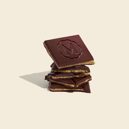 Dark chocolate bar pieces stacked, caramelized cashew filling and embossed Marou logo
