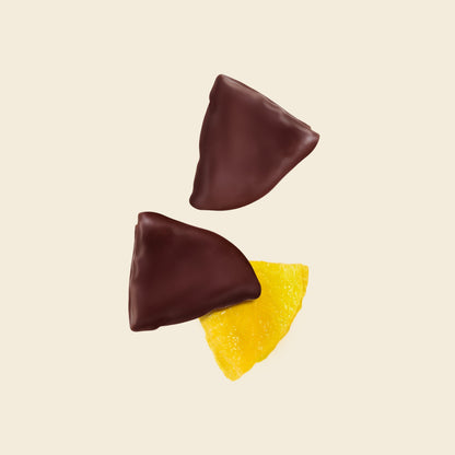 Dark chocolate enrobed passion fruit pieces with yellow fruit filling