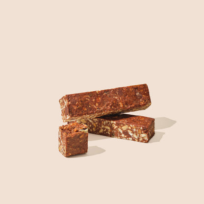 Chocolate protein bar with peanuts, pumpkin seeds, and cashews, sliced pieces