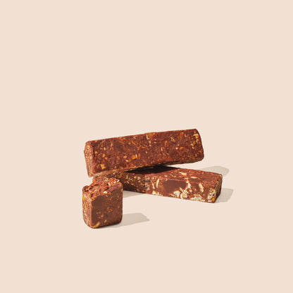 Chocolate energy bar pieces, 65% with fruits, cashews and toasted oats.