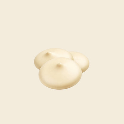 Creamy white chocolate drops, smooth rounded pieces