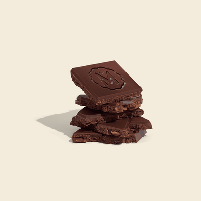 Milk chocolate pieces with sesame rice paper, dark bar stacks