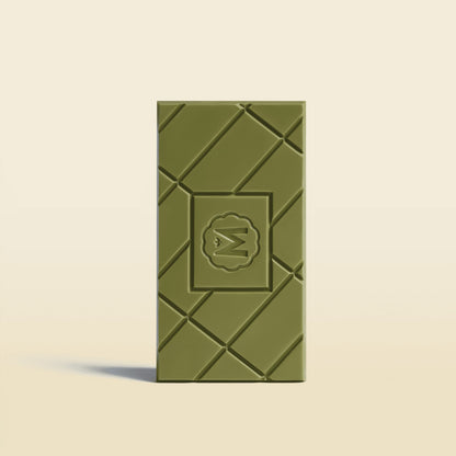 Marou white chocolate bar with green embossed geometric pattern and badge logo